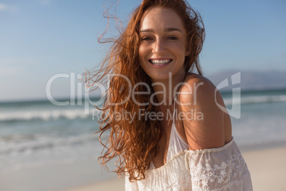 Young woman smiling at camera on the beach