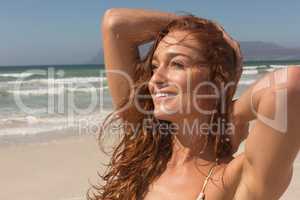 Young woman in bikini looking away on the beach