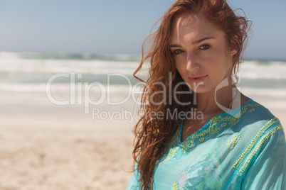 Young Caucasian woman looking at camera on the beach