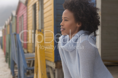 Young African American woman standing at beach hut