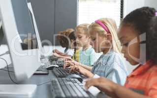 School kids using computer in school