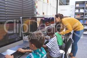 Teacher teaching student in computer room