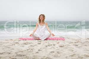 Woman performing yoga at beach