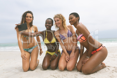 Women with bikini taking selfie on beach