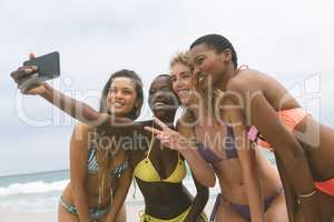 Women with bikini taking selfie on beach