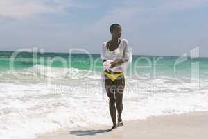 Woman relaxing and standing on beach