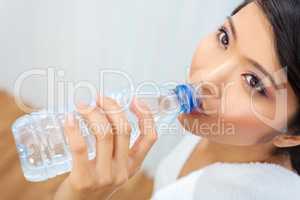 Asian Chinese Girl Drinking Bottle of Water at Gym