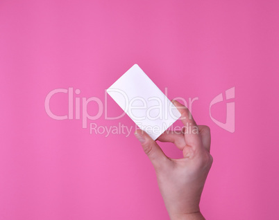 empty white rectangular business card in a female hand
