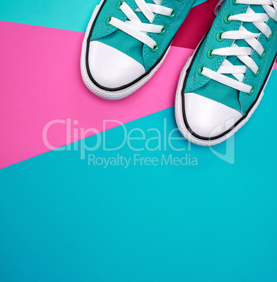 pair of blue textile sneakers on an abstract multicolored backgr