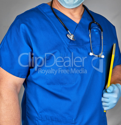 doctor in blue uniform and sterile latex gloves