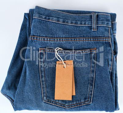 folded blue jeans and tied brown blank tag