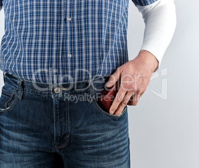 man in blue jeans and a plaid shirt shoves