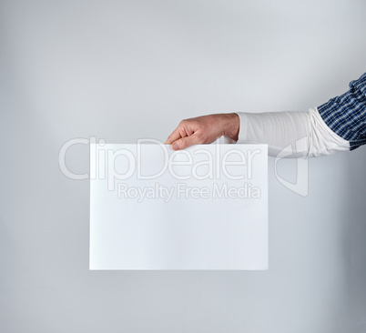 man holding a blank rectangular white paper sheet