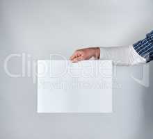 man holding a blank rectangular white paper sheet