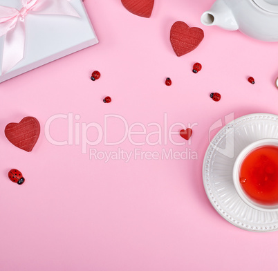 tea with berries of viburnum in a white ceramic cup