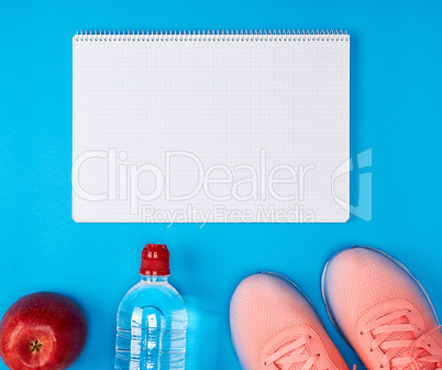 open empty notebook and sports women's clothing for sports and f