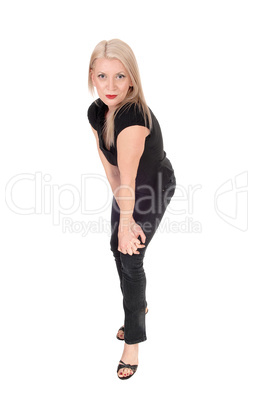 A happy looking blond woman standing in black outfit