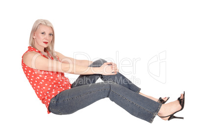 Woman relaxing, sitting on the floor in studio