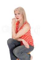 Blond gorgeous middle age woman sitting on chair