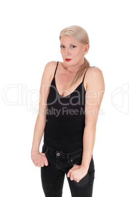 Blond woman standing in a black outfit hands in pocket