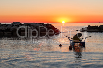 Pedalo moored in the sea during the sunrise