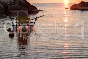 Pedalo moored in the sea at sunrise