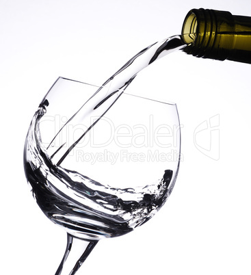 Pouring white wine in a glass