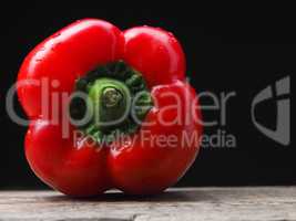 Organic bell pepper on a wooden table