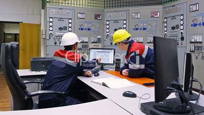 Two engineers near main control panel