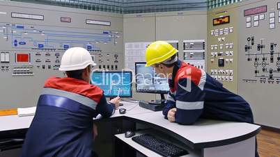 Two engineers near main control panel