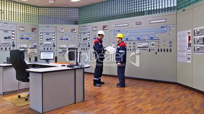 Two engineers near main control panel