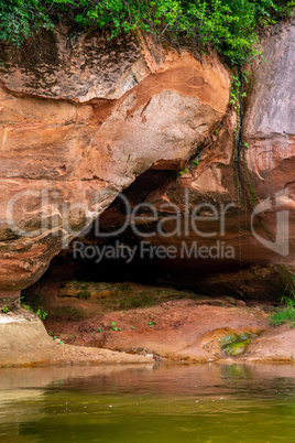 Red sandstone cliff on coast of the river