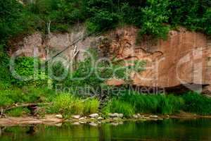 Red sandstone cliff on coast of the river