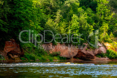 Red sandstone cliff on coast of the river