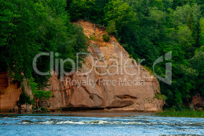 Red sandstone cliff on coast of the river