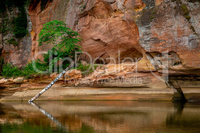 Red sandstone cliff on coast of the river