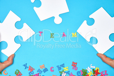 white big puzzles on a blue background,  inscription team