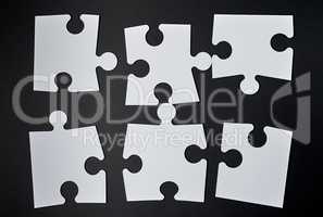 white big puzzles on a black background