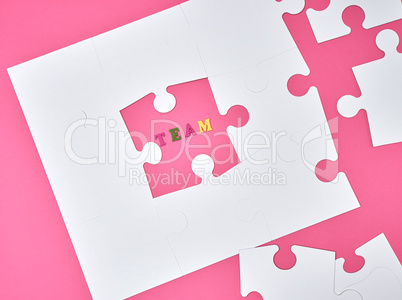 white big puzzles on a pink background, the inscription team,