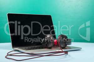 Red earphone on a notebook with a light blue background
