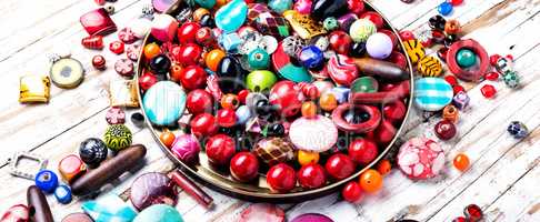 Colorful beads on wooden surface