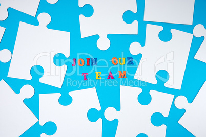 big paper blank white puzzles on a blue background, the inscript