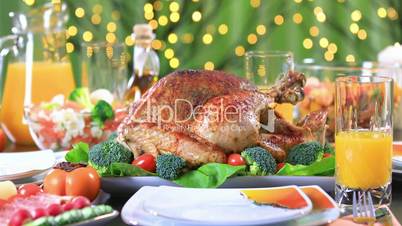 Garnished roasted turkey on festive table closeup