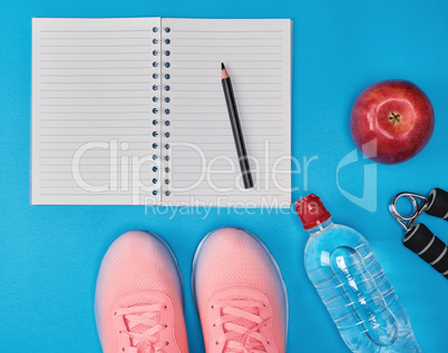open empty notebook and sports women's clothing for sports