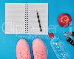 open empty notebook and sports women's clothing for sports