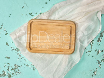 empty wooden cutting board on green background