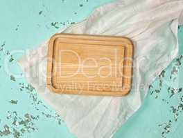 empty wooden cutting board on green background