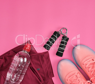 femal sports sneakers and a  water bottle