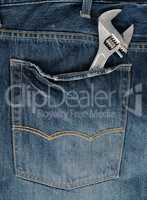 metal adjustable wrench in blue jeans back pocket