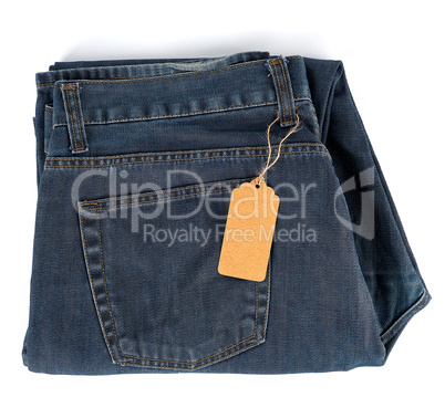 folded blue jeans and tied brown blank tag